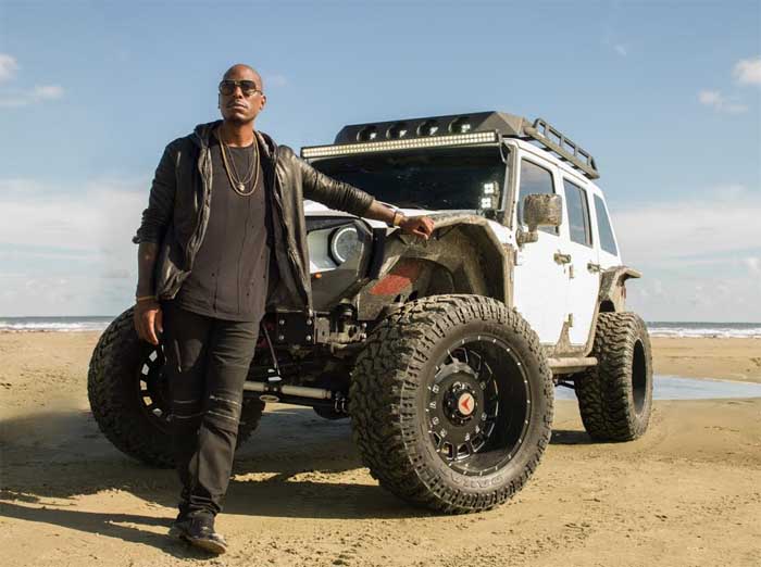 Gibson poses with his customized jeep wrangler.